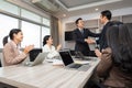 Happy businessman shaking hands at group board meeting. Professional business executive leaders trade partnership handshake