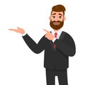 Happy businessman showing hand gesture copy space to present or introduce something and pointing index finger. Presentation. Royalty Free Stock Photo