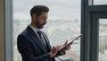 Happy businessman signing document with profitful deal at office window close up Royalty Free Stock Photo