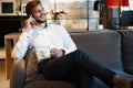 Happy businessman sitting and talking on the phone at office. Royalty Free Stock Photo