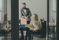 Happy businessman smile at businesswoman in office. Bearded man and woman discuss financial report. Boss and secretary Royalty Free Stock Photo