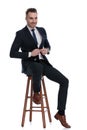 Happy businessman smiling and adjusting his jacket Royalty Free Stock Photo