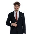 Happy businessman smiling and fixing his jacket Royalty Free Stock Photo