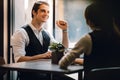 Happy Businessman Smiling while Meeting with his Partnership or Teamwork in Cafe or Creative Workplace. Relaxing and Comfortable Royalty Free Stock Photo