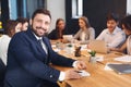 Happy businessman smiling to camera with colleagues on background Royalty Free Stock Photo