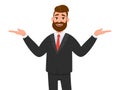 Happy businessman spreading his hands to the sides. Man pointing away and showing or presenting something. Man pointing hands. Royalty Free Stock Photo