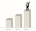 Happy businessman standing on bar chart Royalty Free Stock Photo