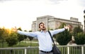 A happy businessman standing on a bridge, screaming and stretching arms. Royalty Free Stock Photo