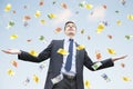 Happy businessman standing in the rain of money Royalty Free Stock Photo