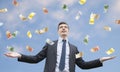 Happy businessman standing in the rain of money Royalty Free Stock Photo