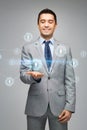 Happy businessman in suit showing network contacts