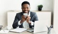 Happy businessman surfing internet on smartphone, working in office Royalty Free Stock Photo