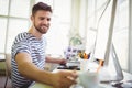 Happy businessman taking coffee cup at creative office Royalty Free Stock Photo