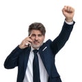 Happy businessman talking on his phone and celebrating Royalty Free Stock Photo