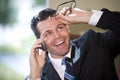 Happy businessman talking on mobile phone