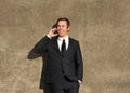 Happy businessman talking on mobile phone outdoors Royalty Free Stock Photo