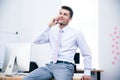 Happy businessman talking on the phone in office Royalty Free Stock Photo