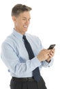 Happy Businessman Text Messaging Through Smart Phone Royalty Free Stock Photo