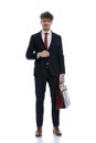 Happy businessman unbuttoning his jacket and holding briefcase Royalty Free Stock Photo