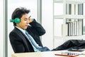 Happy businessman using headphones listen to music during break at workplace. employee male enjoying favorite track, listening to