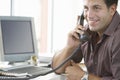 Happy Businessman Using Landline Phone In Office Royalty Free Stock Photo