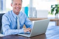 Happy businessman using laptop computer Royalty Free Stock Photo