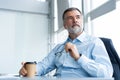 Happy businessman using laptop computer in office. Royalty Free Stock Photo