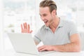 Happy businessman using laptop and gesturing Royalty Free Stock Photo