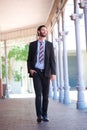 Happy businessman walking outside on sidewalk in the city Royalty Free Stock Photo