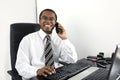 Happy businessman working at desk smiling