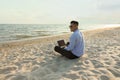 Happy businessman working with laptop on beach. Business trip Royalty Free Stock Photo