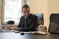 happy businessman working on laptop in office sitting next to dog with a tie Royalty Free Stock Photo