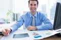 Happy businessman writing at his desk Royalty Free Stock Photo