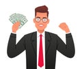 A happy businessman. A young man with glasses holds dollar bills in his hand. A handsome man in a business suit with money in his Royalty Free Stock Photo