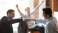 Happy businessmen workers giving fist bump celebrating team project success Royalty Free Stock Photo