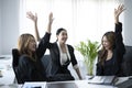 Happy business people celebrating corporate victory together in office. Royalty Free Stock Photo