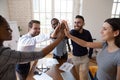 Happy businesspeople celebrating success at common business giving high five