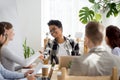 Happy businesspeople handshaking in office at meeting