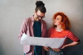 Happy businesspeople laughing while collaborating on a new project in an office. Business startup. Royalty Free Stock Photo