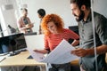 Happy businesspeople laughing while collaborating on a new project in an office. Business startup. Royalty Free Stock Photo