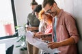 Happy businesspeople laughing while collaborating on a new project in an office. Business startup. Royalty Free Stock Photo