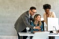 Happy businesspeople laughing while collaborating on a new project in an office. Royalty Free Stock Photo