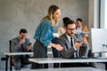 Happy businesspeople laughing while collaborating on a new project in an office. Royalty Free Stock Photo