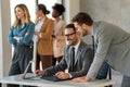 Happy businesspeople laughing while collaborating on a new project in an office. Royalty Free Stock Photo