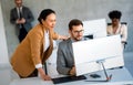 Happy businesspeople laughing while collaborating on a new project in an office. Royalty Free Stock Photo