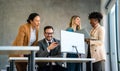 Happy businesspeople laughing while collaborating on a new project in an office. Royalty Free Stock Photo