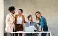 Happy businesspeople laughing while collaborating on a new project in an office. Royalty Free Stock Photo