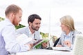 Happy businesspeople reading menu at sidewalk cafe Royalty Free Stock Photo