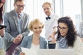 Happy businesspeople working on laptop in creative office Royalty Free Stock Photo