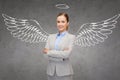 Happy businesswoman with angel wings and nimbus Royalty Free Stock Photo